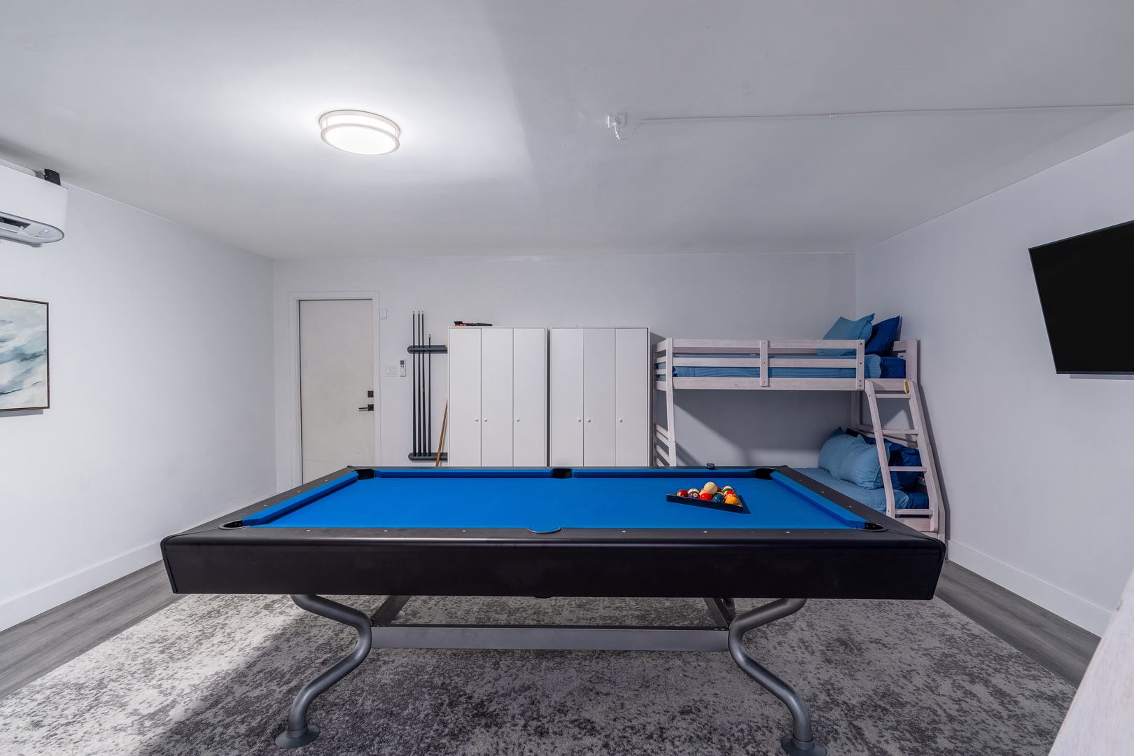 Challenge friends to a game of pool in this bright game room, complete with a cozy bunk bed and wall-mounted TV for endless entertainment after the sun sets.