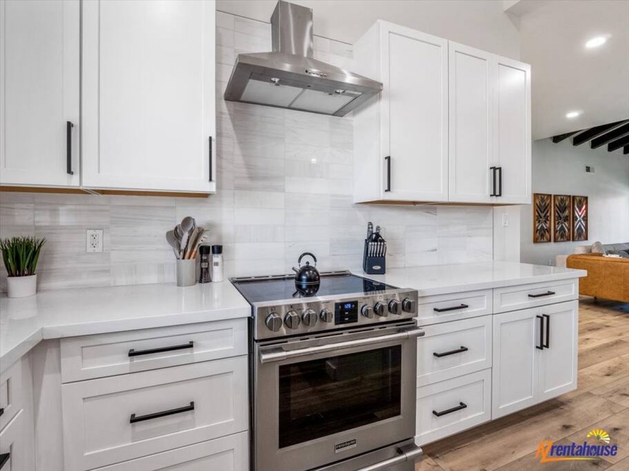 Your fully equipped gourmet kitchen invites culinary adventures with premium stainless steel appliances, pristine white cabinetry, and elegant marble countertops.