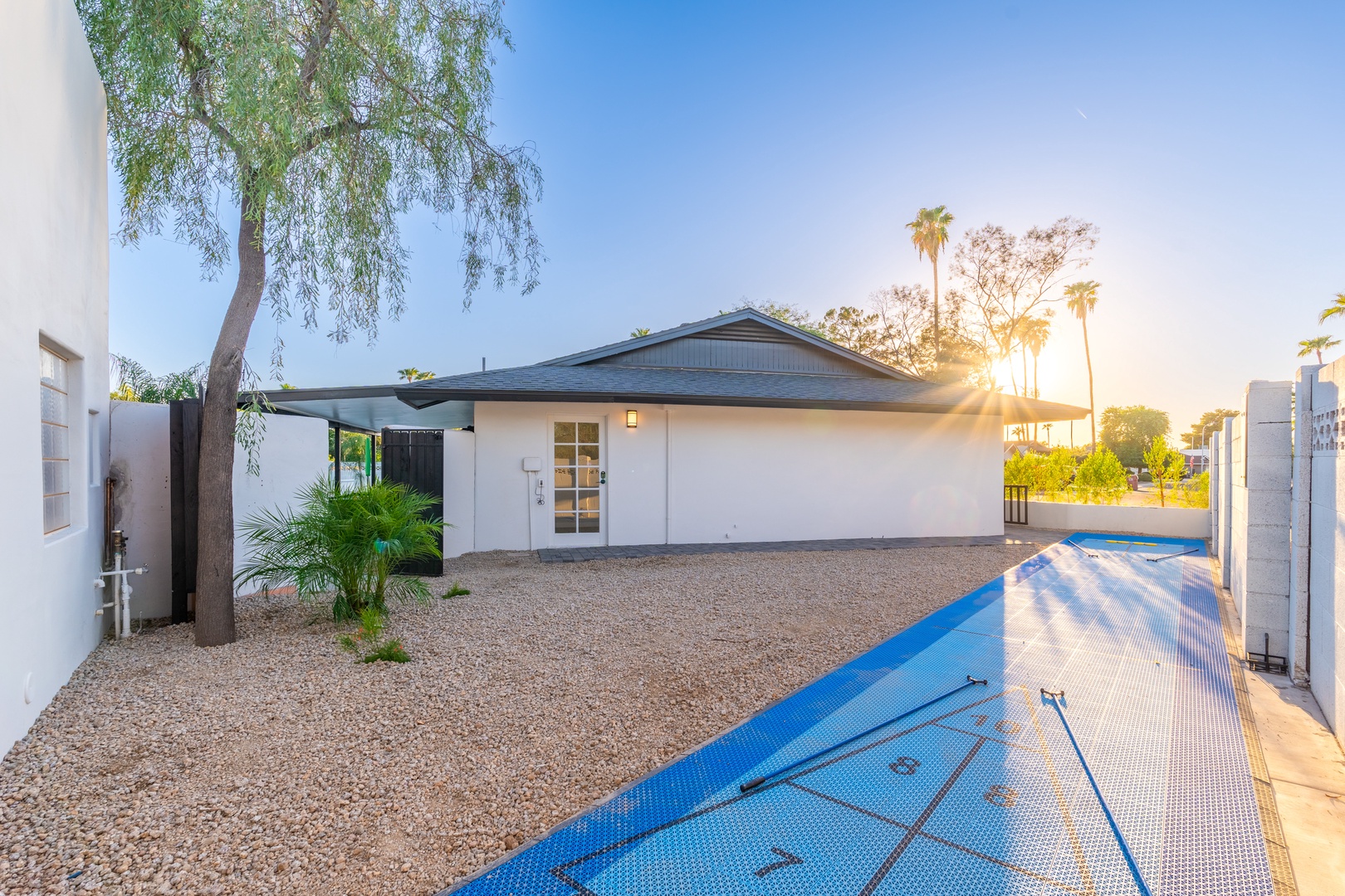 This vacation rental features a private swimming pool and well-maintained front courtyard, set in a sunny, palm-studded neighborhood ideal for relaxation.