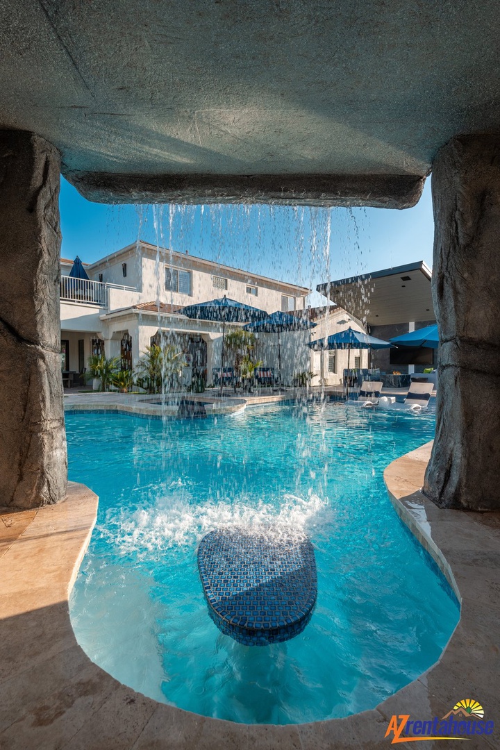 Dive into your private paradise through this stunning rock grotto, where cascading waterfalls create the perfect backdrop for unforgettable pool days.