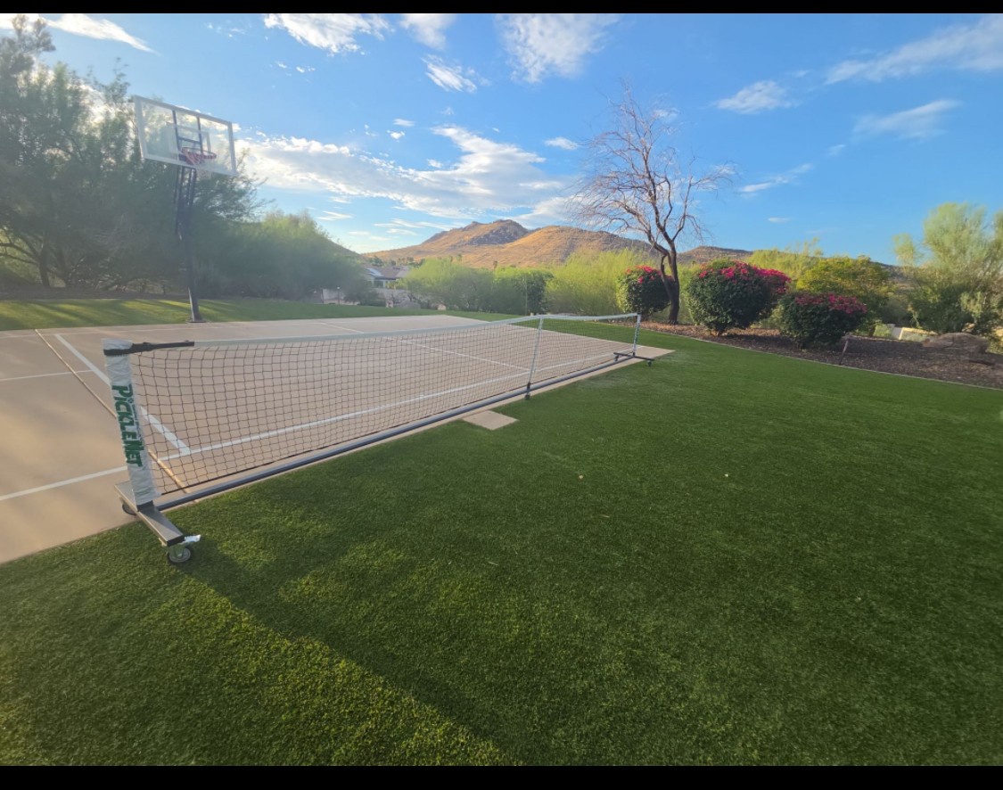 Private tennis court with mountain backdrop, perfect for your morning match or friendly game under sunny desert skies surrounded by manicured landscaping.