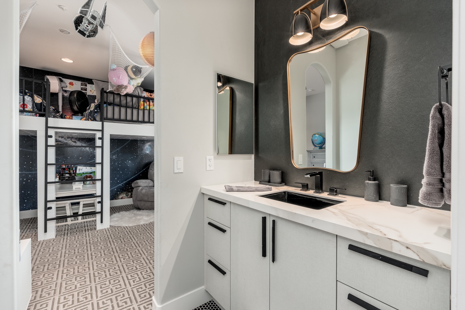 Stylish vanity with a modern mirror and soft lighting invites you to refresh before heading out. The sleek countertop and elegant fixtures add a touch of luxury.