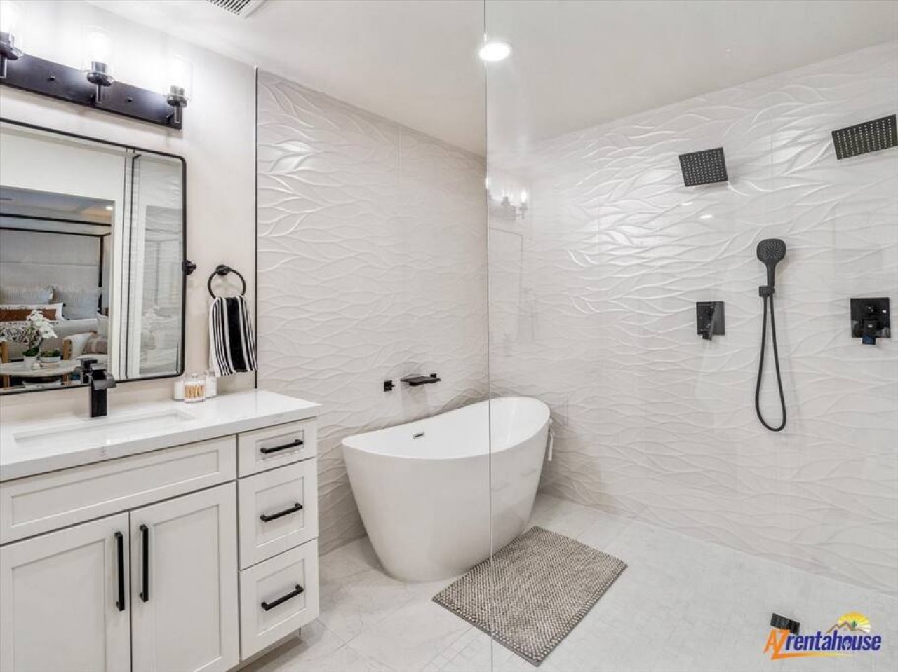 Step into your luxurious spa-like bathroom featuring a gleaming soaking tub and spacious walk-in shower with striking textured walls.