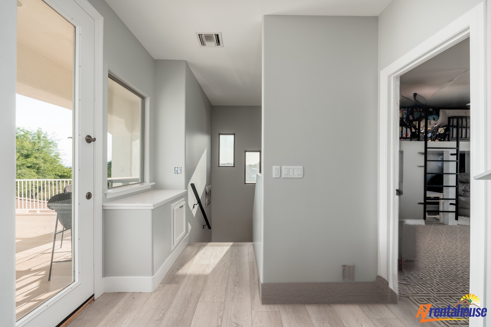 Your modern second-floor landing offers built-in storage and bright natural light from glass doors leading to your private balcony.