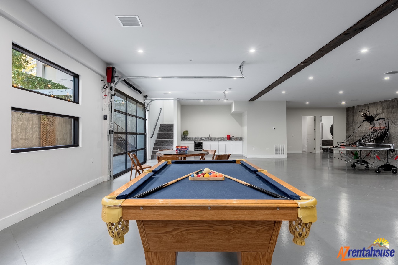 Challenge friends to pool in your spacious rec room with sleek design and modern industrial touches.