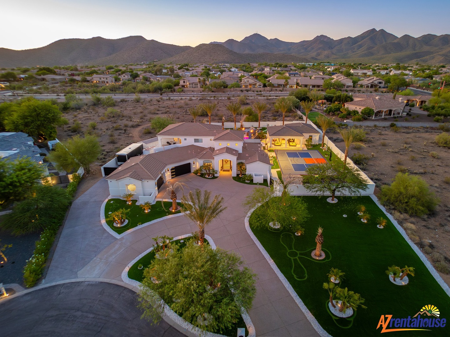 Spectacular desert estate with manicured grounds and mountain backdrop showcasing the property's prime location.