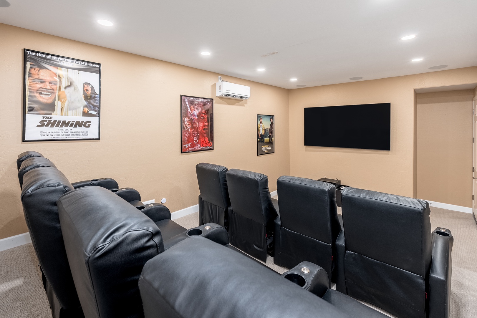 Settle into plush theater seating and enjoy your favorite films on the big screen in this private home cinema, complete with cozy recliners and classic movie posters.