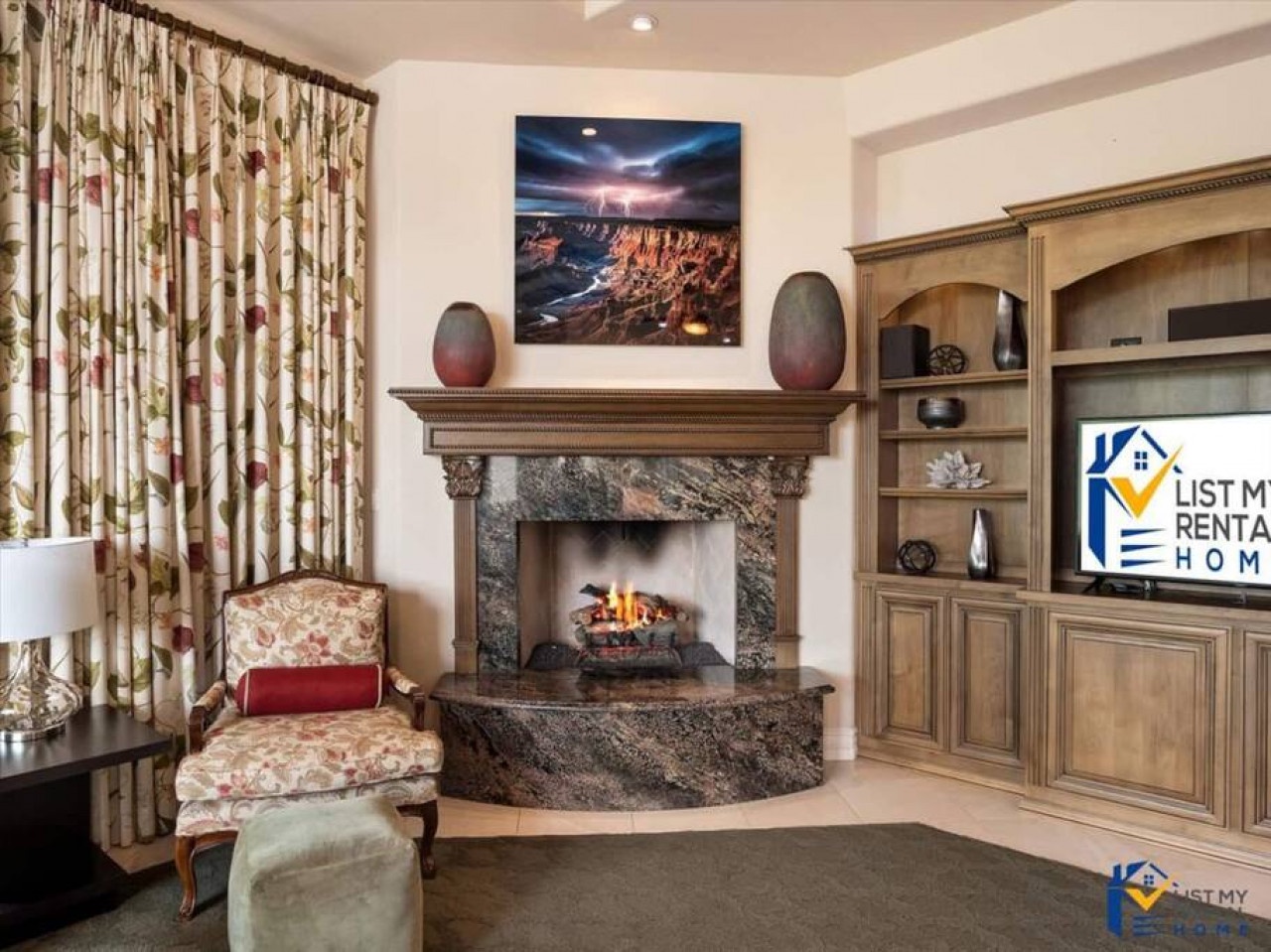 Relax in this elegant living room featuring a stunning stone fireplace, built-in entertainment center, and cozy seating perfect for your evening gatherings.