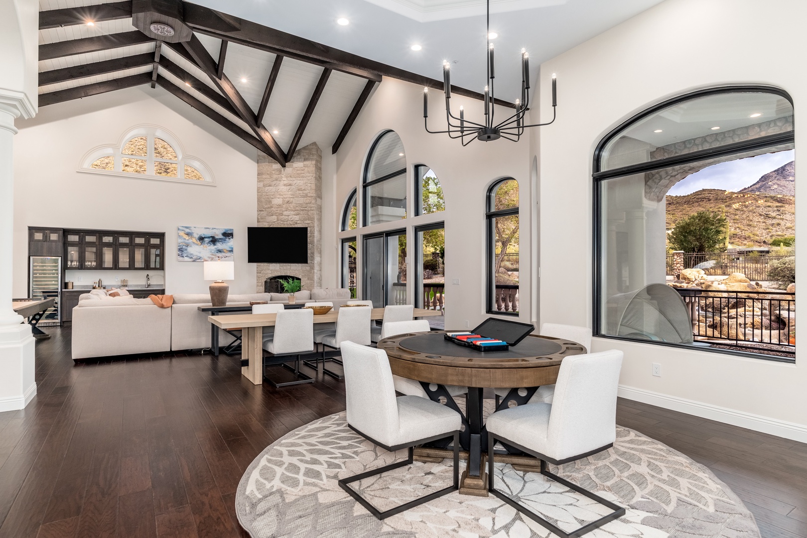 Experience open-concept elegance with soaring vaulted ceilings, a cozy fireplace, and sweeping desert mountain views. Your perfect retreat blends modern comfort with inviting spaces to unwind.