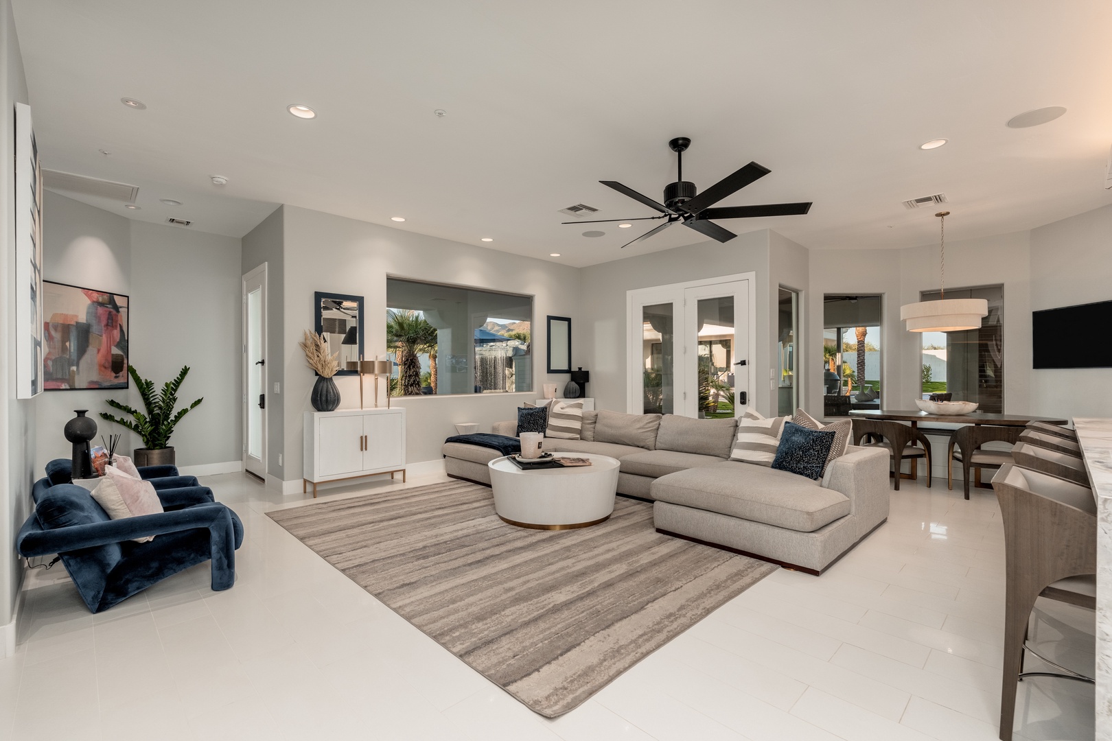 Sink into plush seating in your bright, open living area, where modern comfort meets sophisticated style and natural light flows through elegant glass doors.