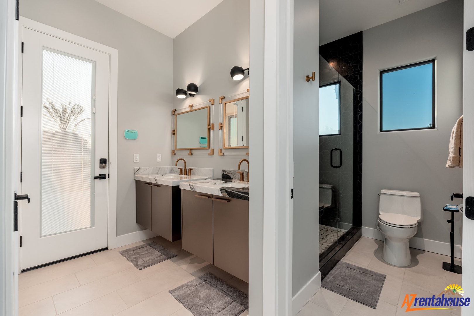 Step into your luxurious ensuite bathroom featuring dual vanities, elegant fixtures, and a spacious glass-enclosed shower for your ultimate comfort.