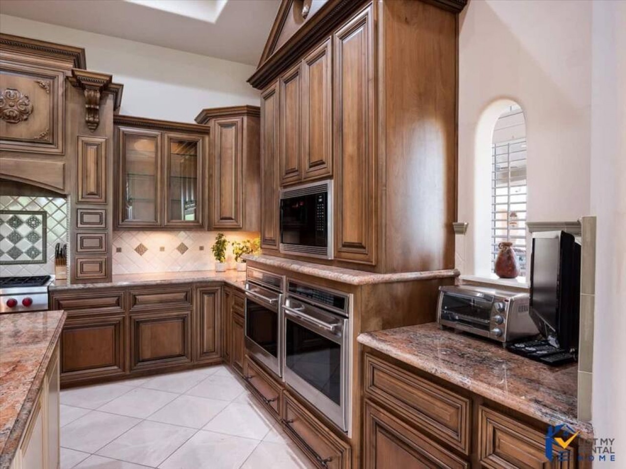 Your gourmet kitchen features rich wood cabinetry, granite countertops, and premium appliances for culinary adventures.