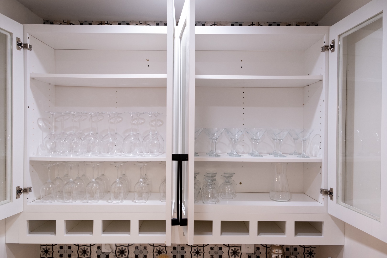 Your kitchen cabinet is stocked with elegant glassware, ready for your evening wine or morning juice, with adjustable shelves for your personal touch.