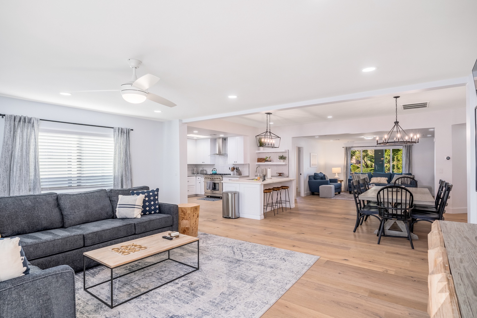 Picture yourself unwinding in this bright, open-concept living space, where warm wood floors flow seamlessly from your cozy living area through the chef-ready kitchen to the inviting dining room—perfect for gathering with loved ones.