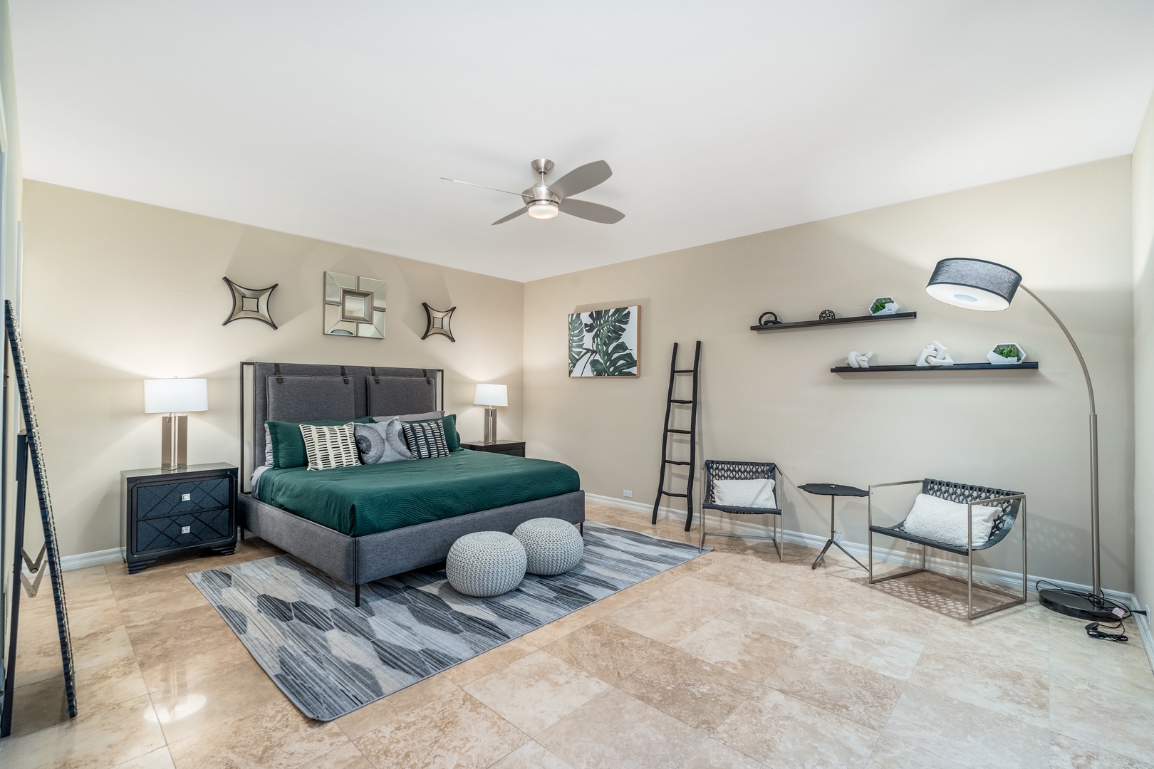 Slip into a spacious bedroom where modern elegance meets comfort. Plush teal bedding invites restful nights, while stylish seating and thoughtful décor create your perfect retreat.