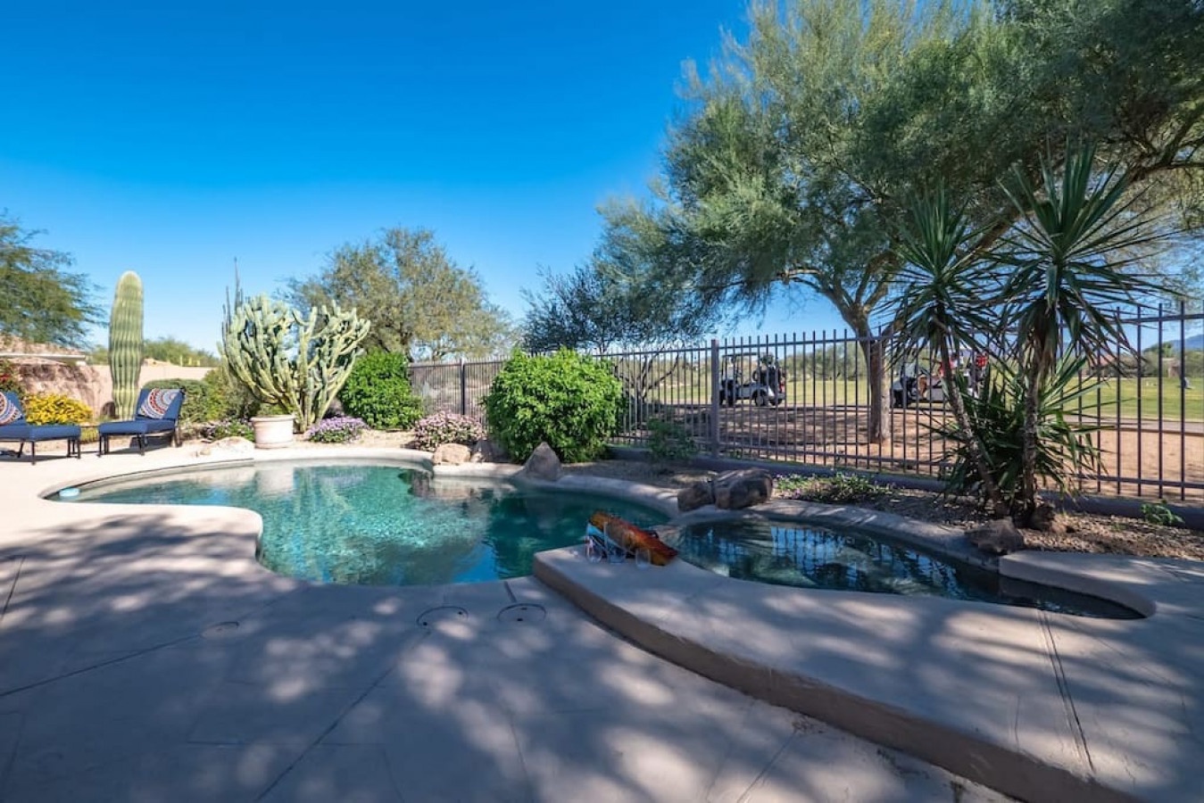 Dive into your private desert oasis! This sparkling pool beckons with crystal-clear waters, surrounded by authentic cacti and desert landscaping for pure Arizona bliss.