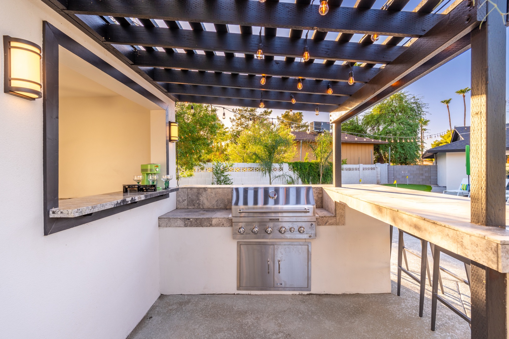 Step outside to your private outdoor kitchen—grill meals under string lights and dine alfresco in the warm evening air, surrounded by lush greenery and complete relaxation.