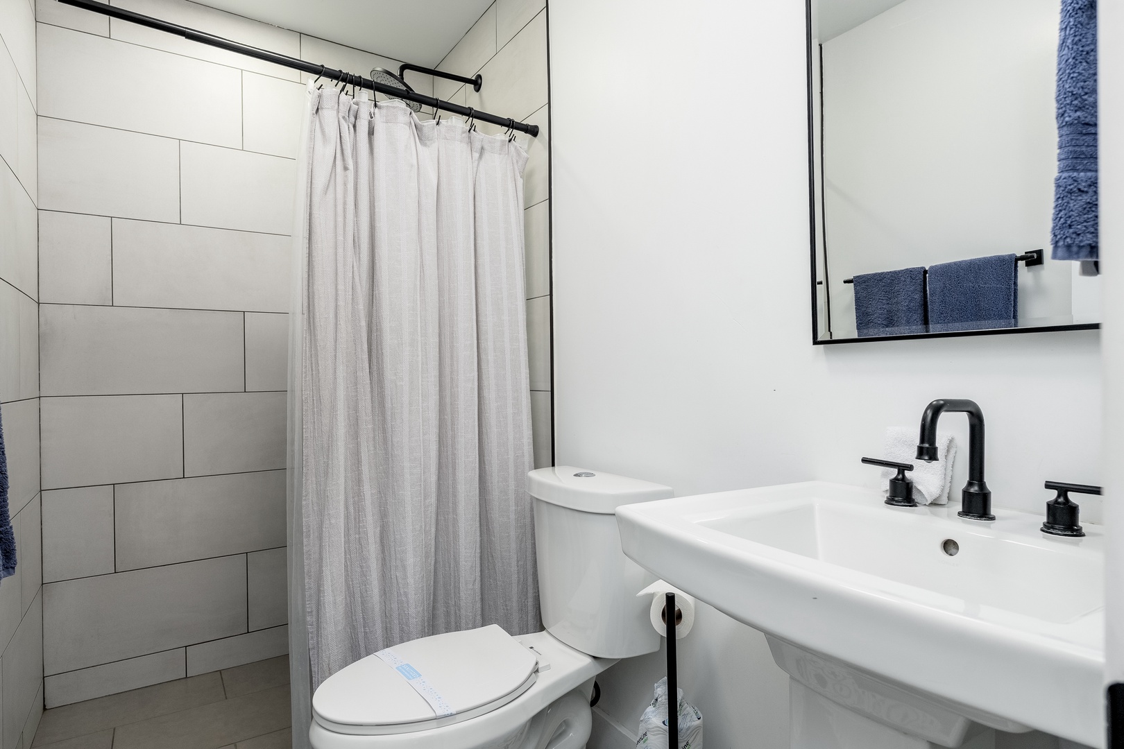 Your private bathroom features modern fixtures, a walk-in shower, and fresh towels waiting for you. The sleek design and clean lines create a relaxing retreat after your adventures.