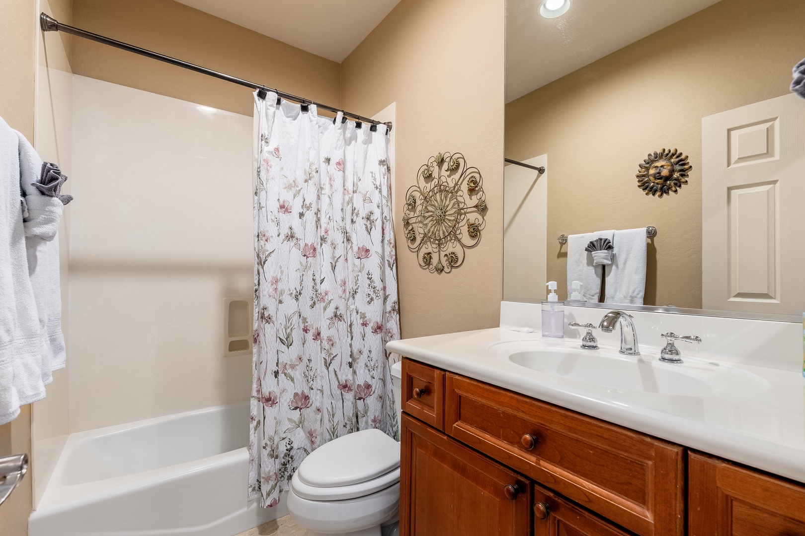 Freshen up in your private bathroom with warm finishes, a tub-shower combo, and charming floral accents that bring a touch of home.