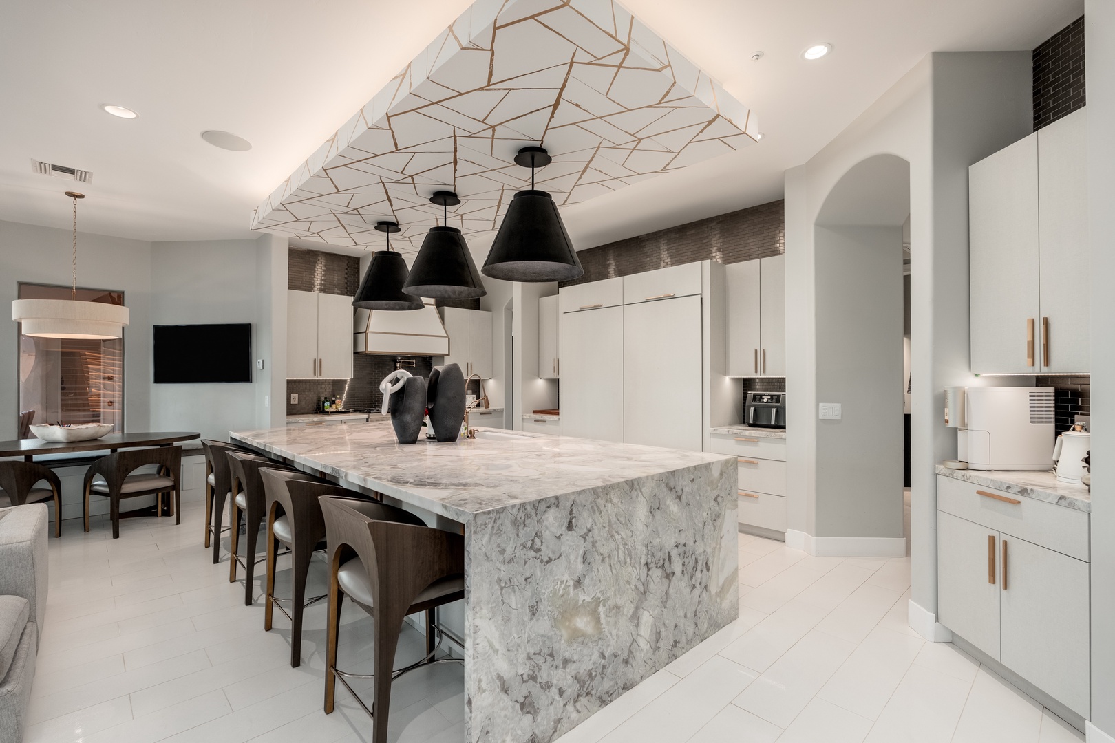 Gather around the stunning marble island in your fully-equipped gourmet kitchen, where sleek modern design meets everything you need to create memorable meals together.