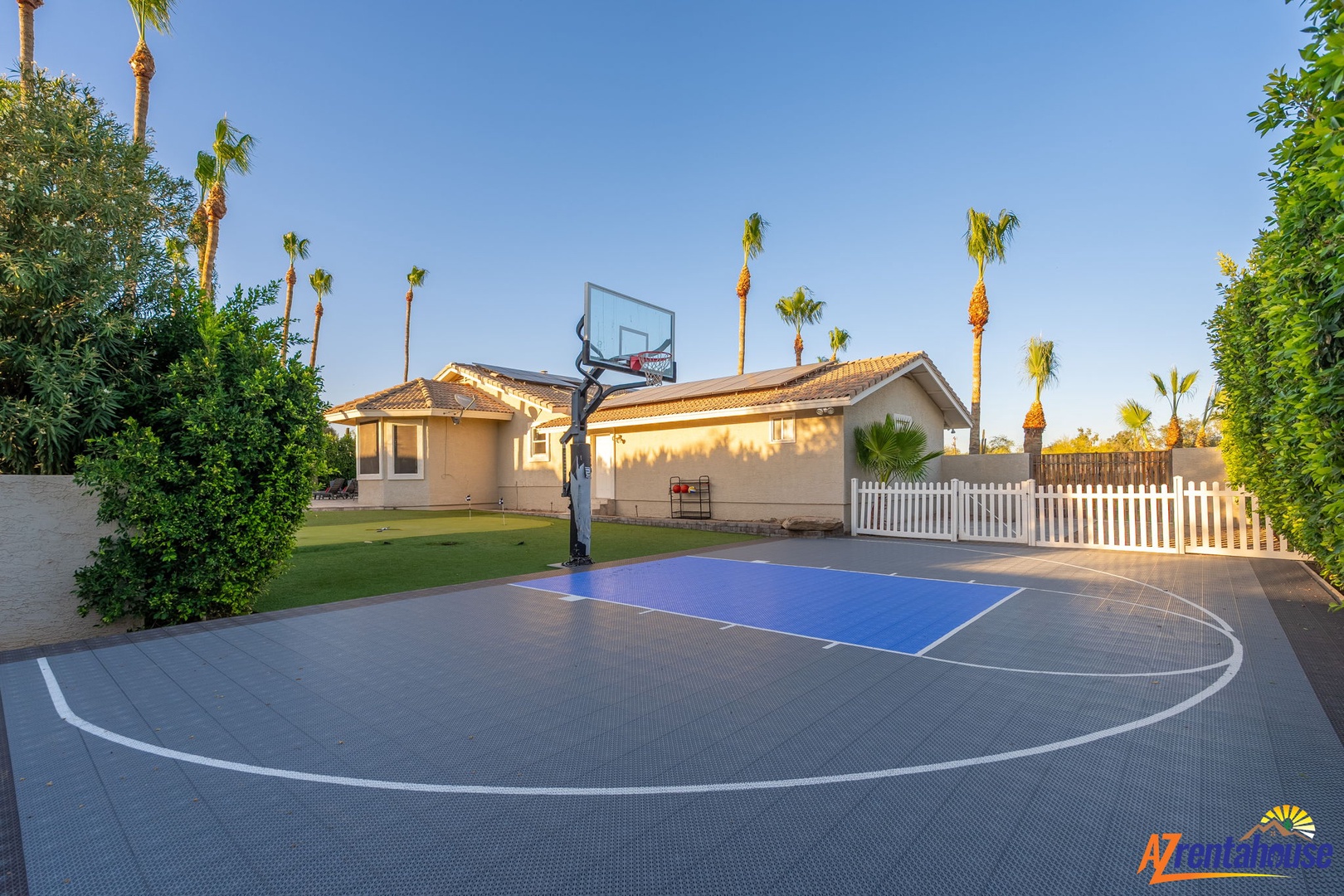 Private outdoor basketball court framed by palm trees and tropical landscaping, offering a dedicated space for active fun and friendly games during your stay.