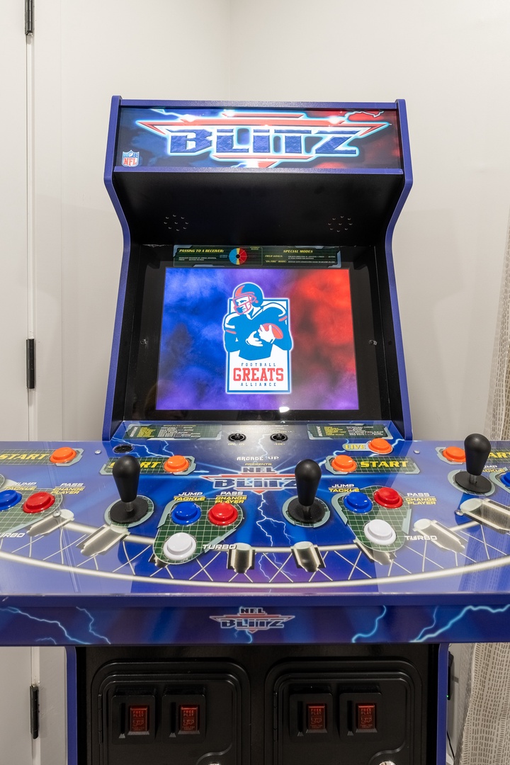 Challenge your friends to a classic arcade showdown on this vintage gaming machine with multiple joysticks and buttons for multiplayer fun.