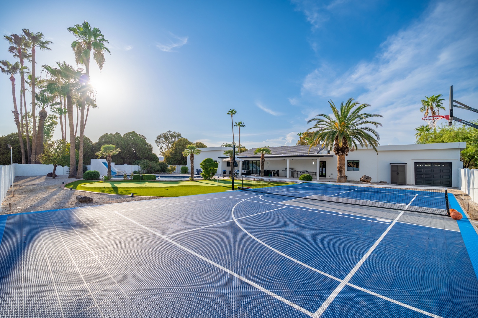 Modern property featuring a private sport court set among manicured lawns and tropical palms. Perfect for active getaways with pool and entertainment areas just steps away.