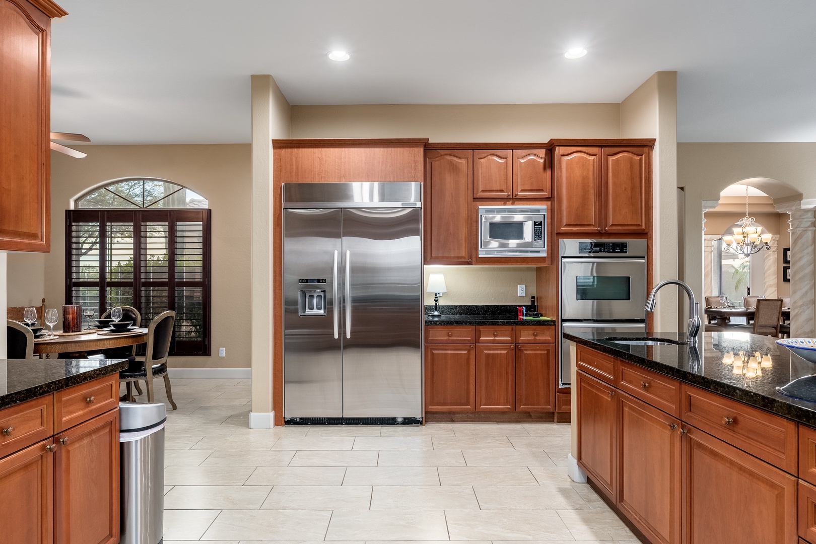 Your fully equipped gourmet kitchen features rich wood cabinetry, sleek stainless steel appliances, and polished granite countertops—perfect for preparing memorable meals during your stay.