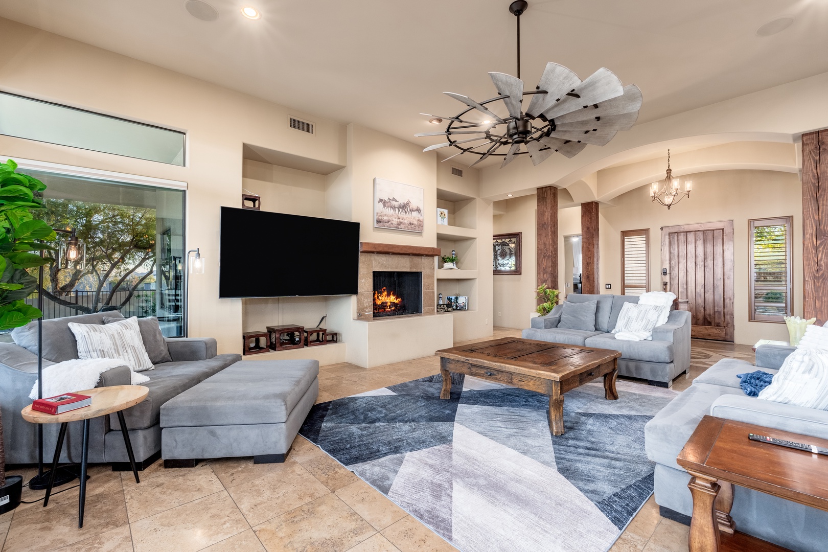 Relax in your bright, airy living room with plush seating, a cozy fireplace, and a stylish blend of rustic wood and modern accents. Perfect for unwinding after a day of adventure.
