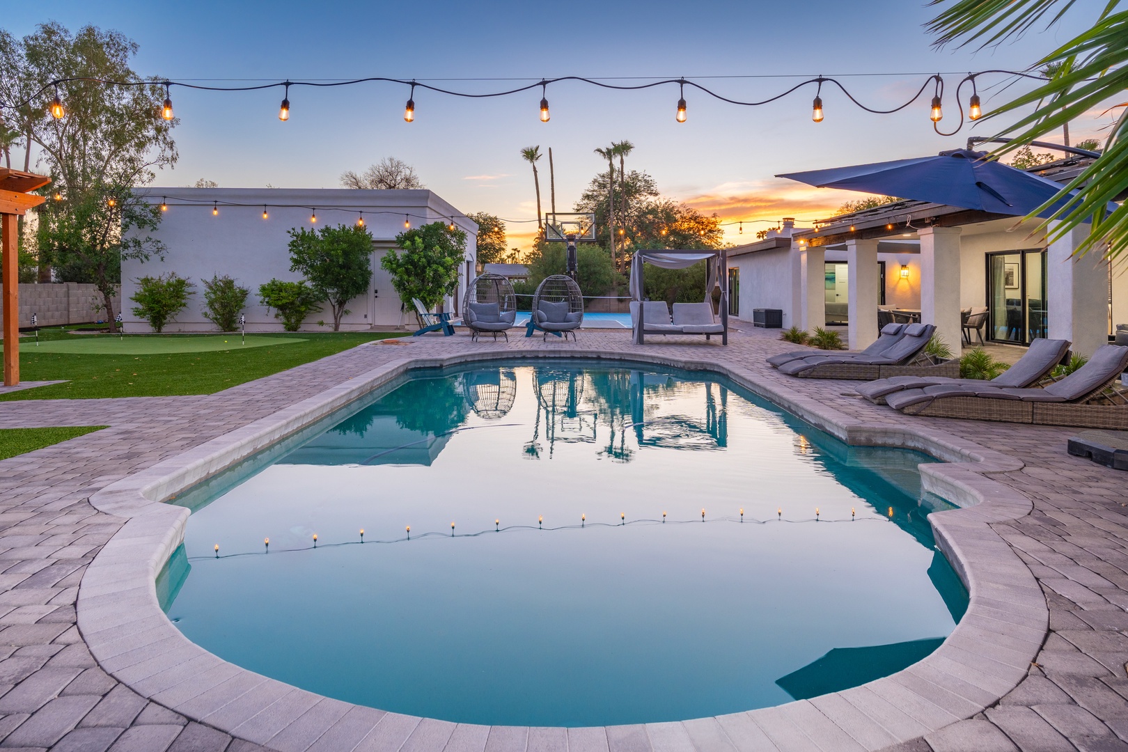 Immerse yourself in sunset views from your private pool oasis. Lounge on sunbeds under palm trees and string lights as daylight melts into golden hour.