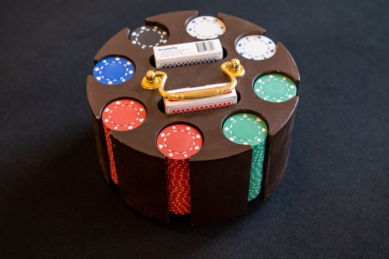 A poker set ready for game night, complete with colorful chips, cards, and a dealer button—perfect for friendly competition with fellow travelers.
