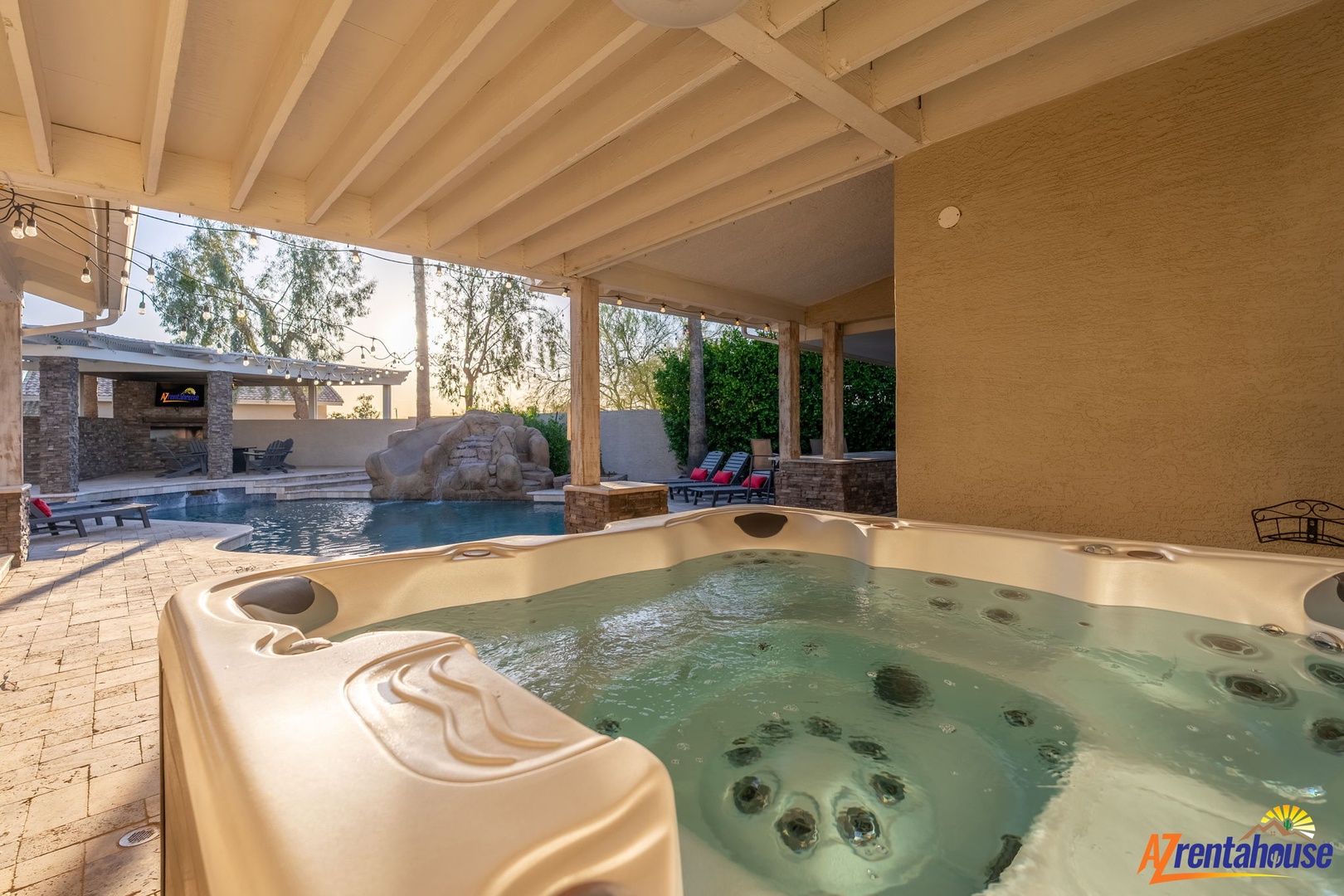 Soak in your private hot tub under a covered patio, overlooking the sparkling pool and outdoor entertainment area—pure desert luxury awaits you.