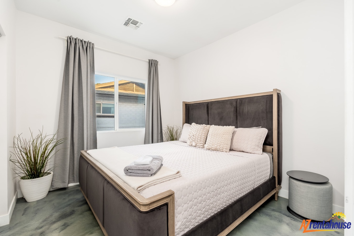 Sink into crisp white bedding and wake refreshed in your serene bedroom, complete with blackout curtains for perfect sleep.