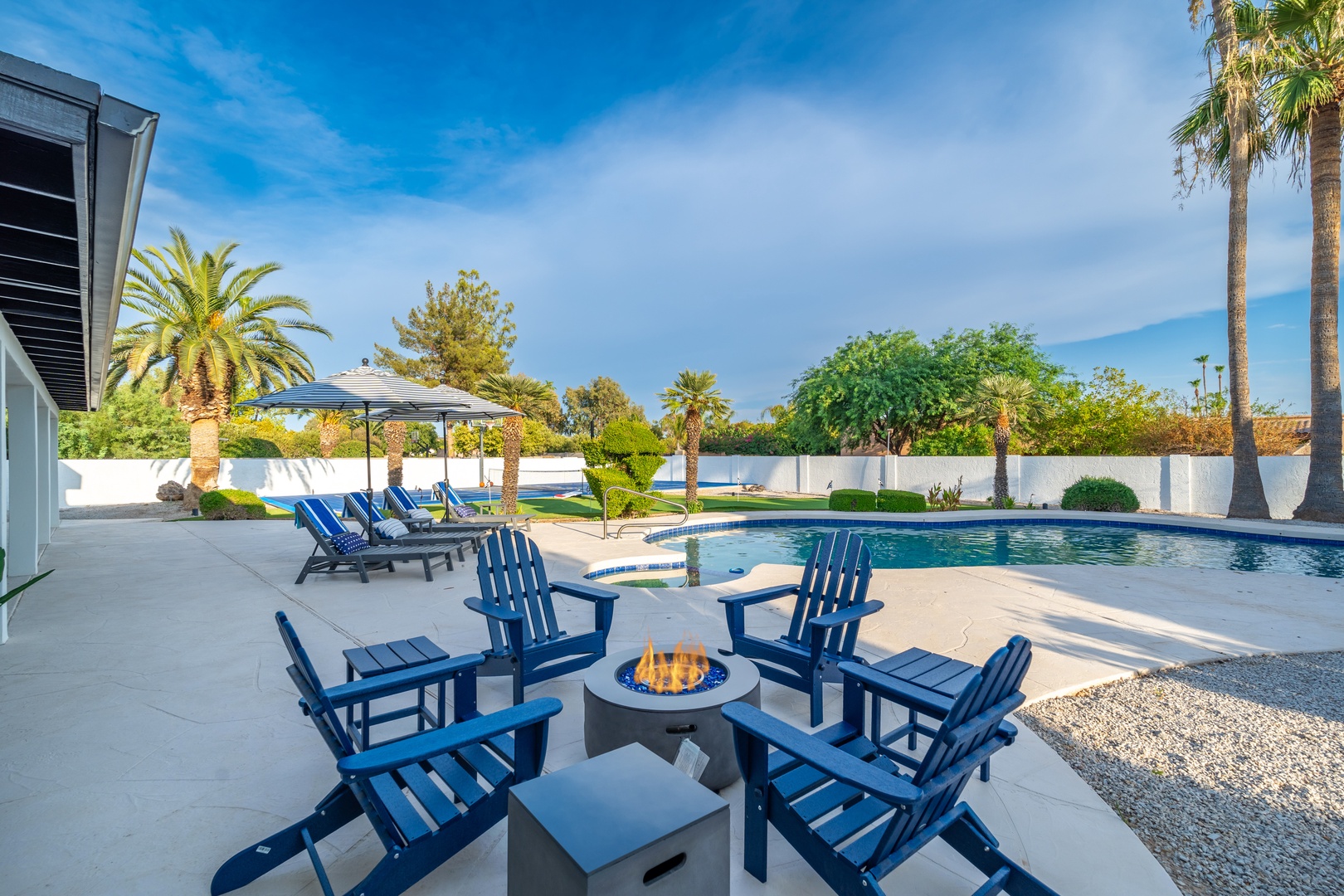 Soak up the sun beside your private pool, surrounded by swaying palms and comfortable lounge chairs perfect for lazy afternoons and evening gatherings around the fire pit.