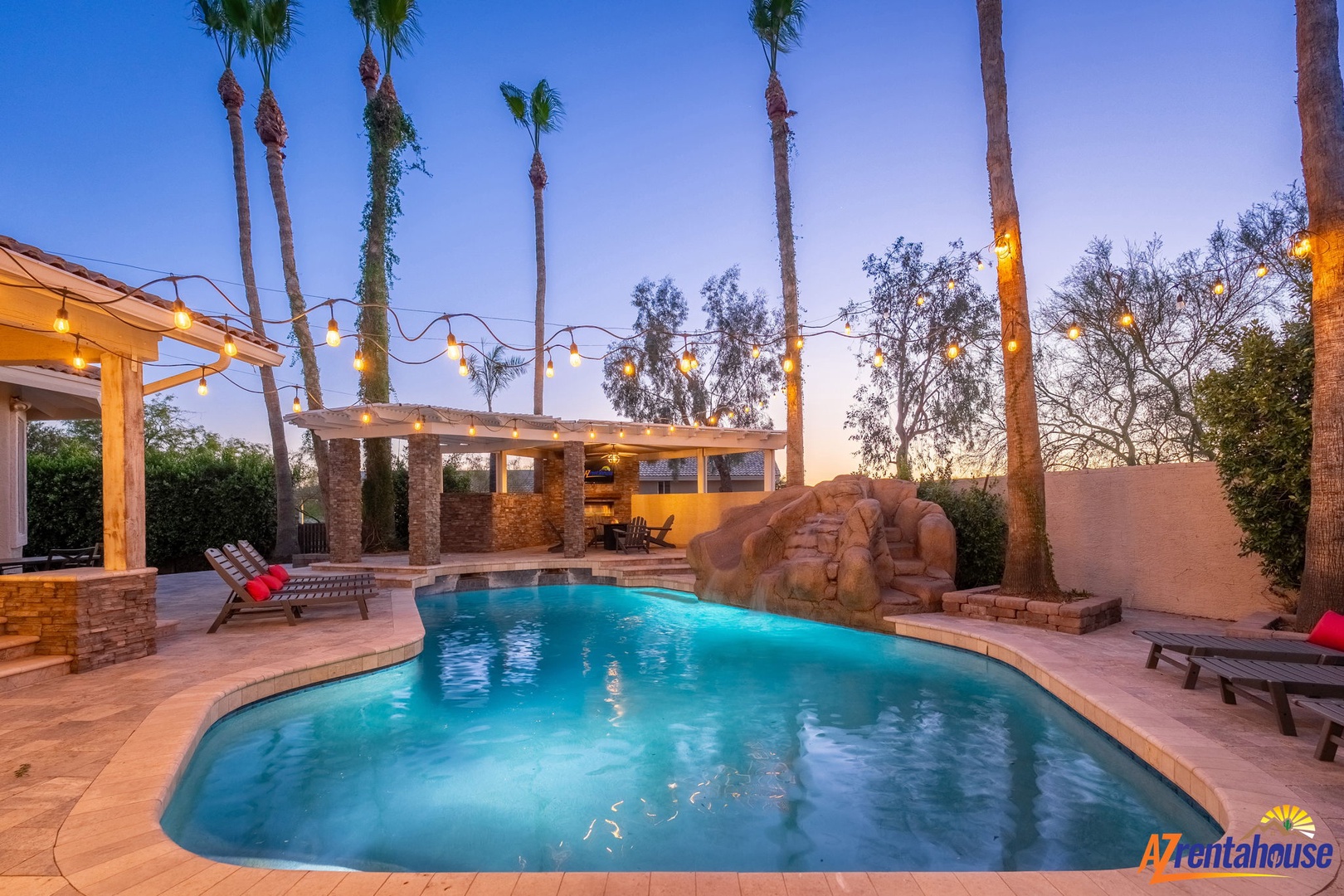 Dusk transforms your private pool into a glowing oasis beneath swaying palms and twinkling lights—perfect for evening swims or lounging poolside under desert skies.