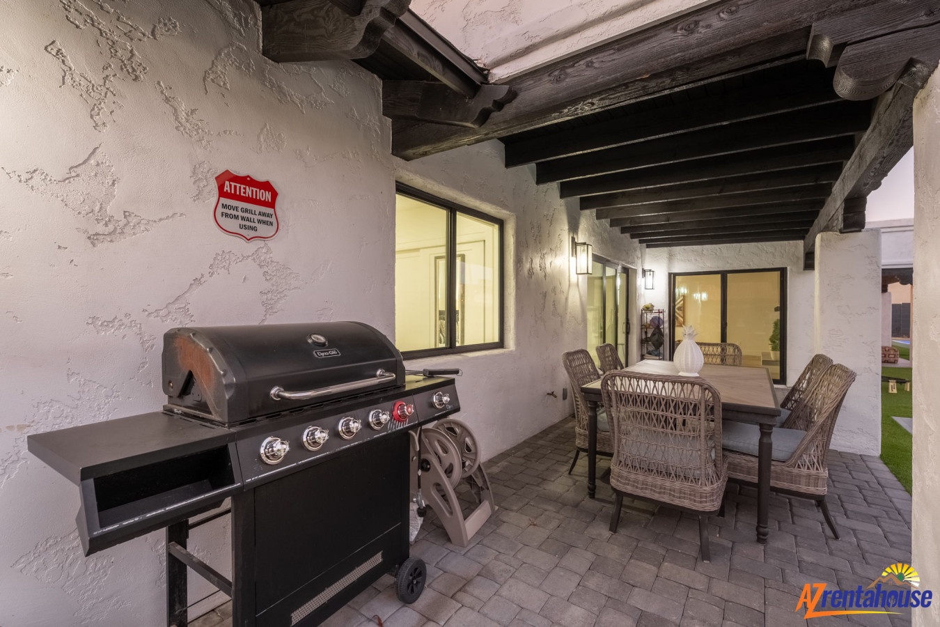 Fire up the grill on your private covered patio, where rustic beams frame the perfect outdoor dining experience for memorable evenings.