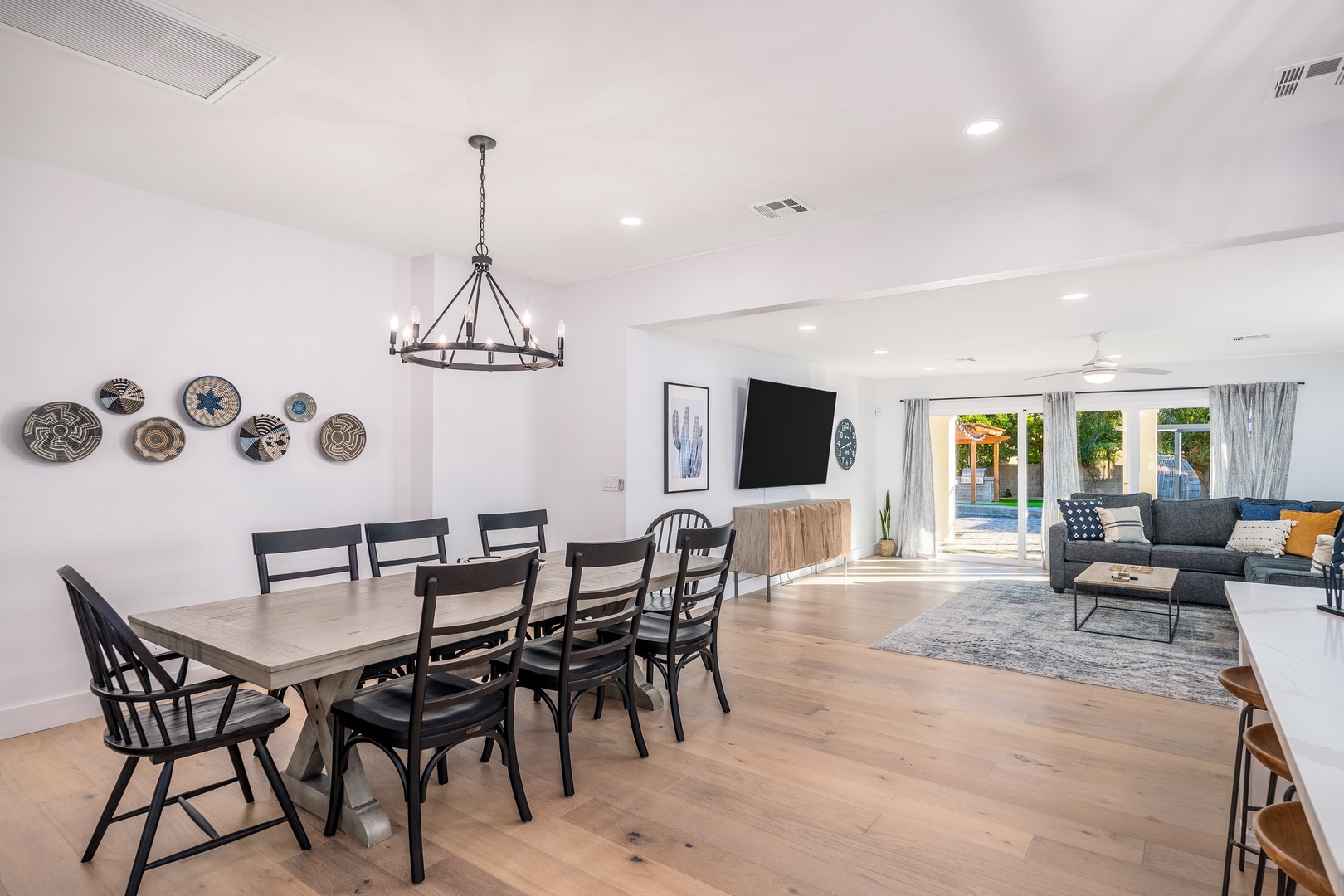 Gather around the handsome dining table for memorable meals, then unwind in your spacious living room where sunlight pours in through patio doors framing your private backyard oasis.