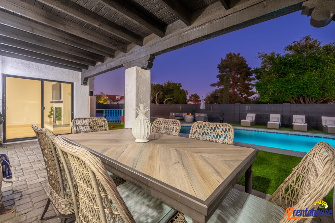 Dine al fresco under rustic wooden beams while your private pool glows softly in twilight's embrace.