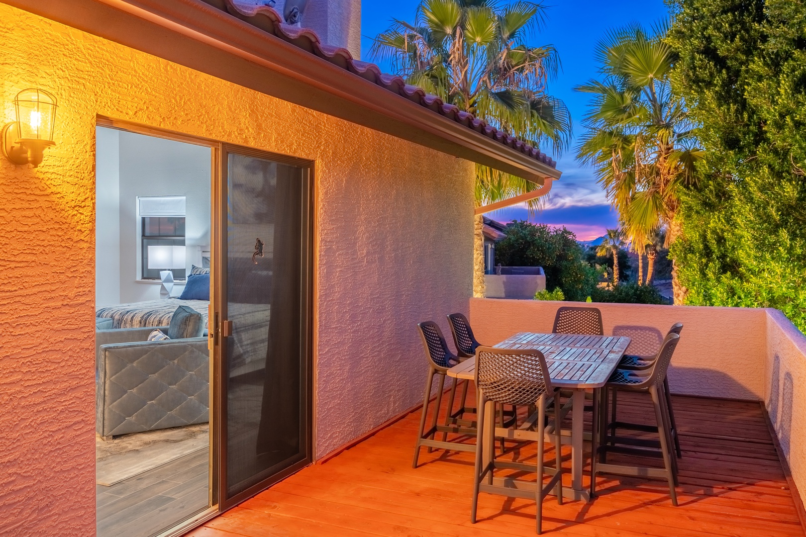 The private balcony offers a peaceful retreat framed by swaying palms and twilight skies, where your evening meals become moments to remember against a stunning desert backdrop.