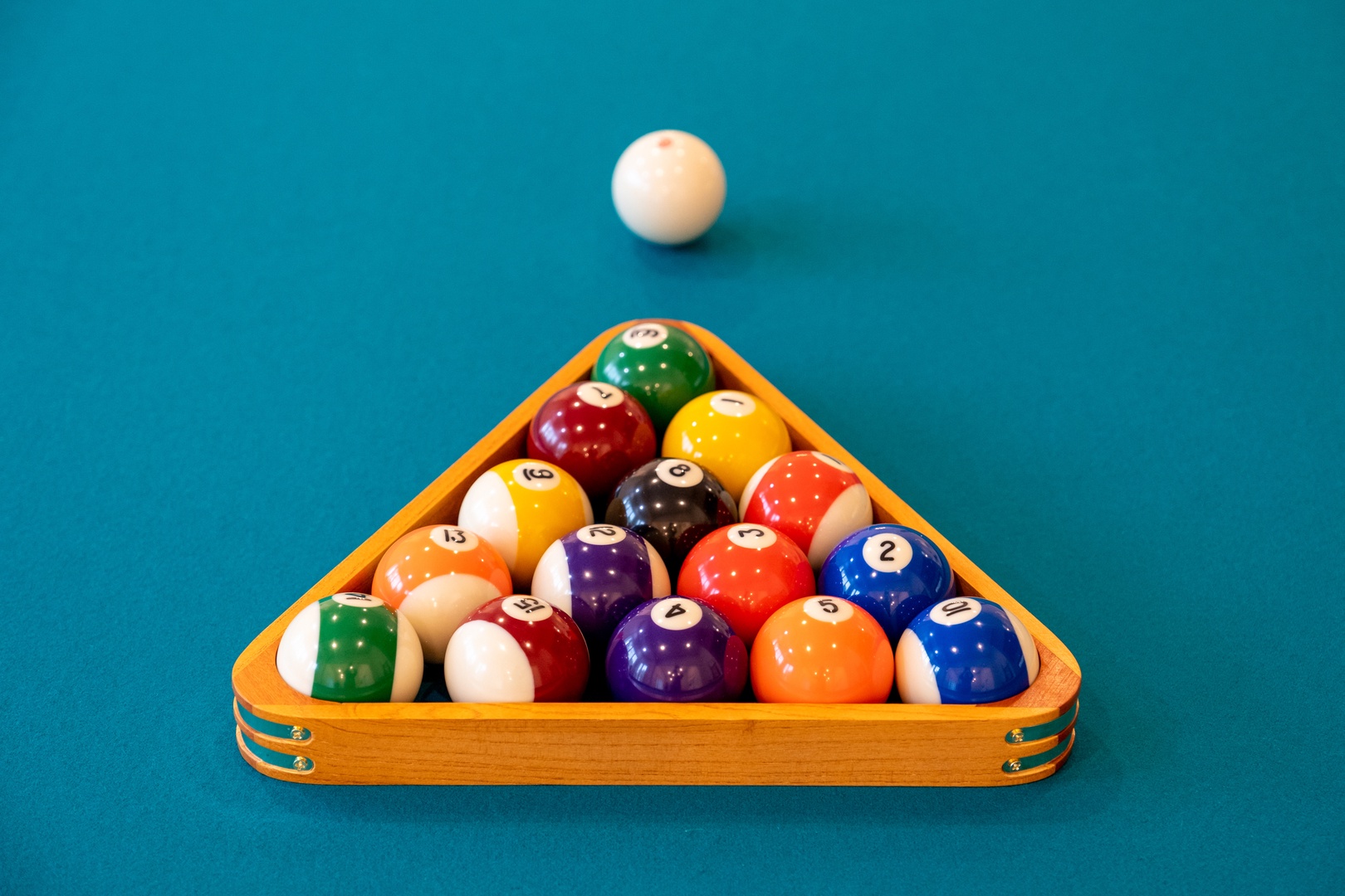 Challenge friends to a friendly game of pool on the vibrant table, complete with professional-grade balls and wooden rack for endless entertainment.