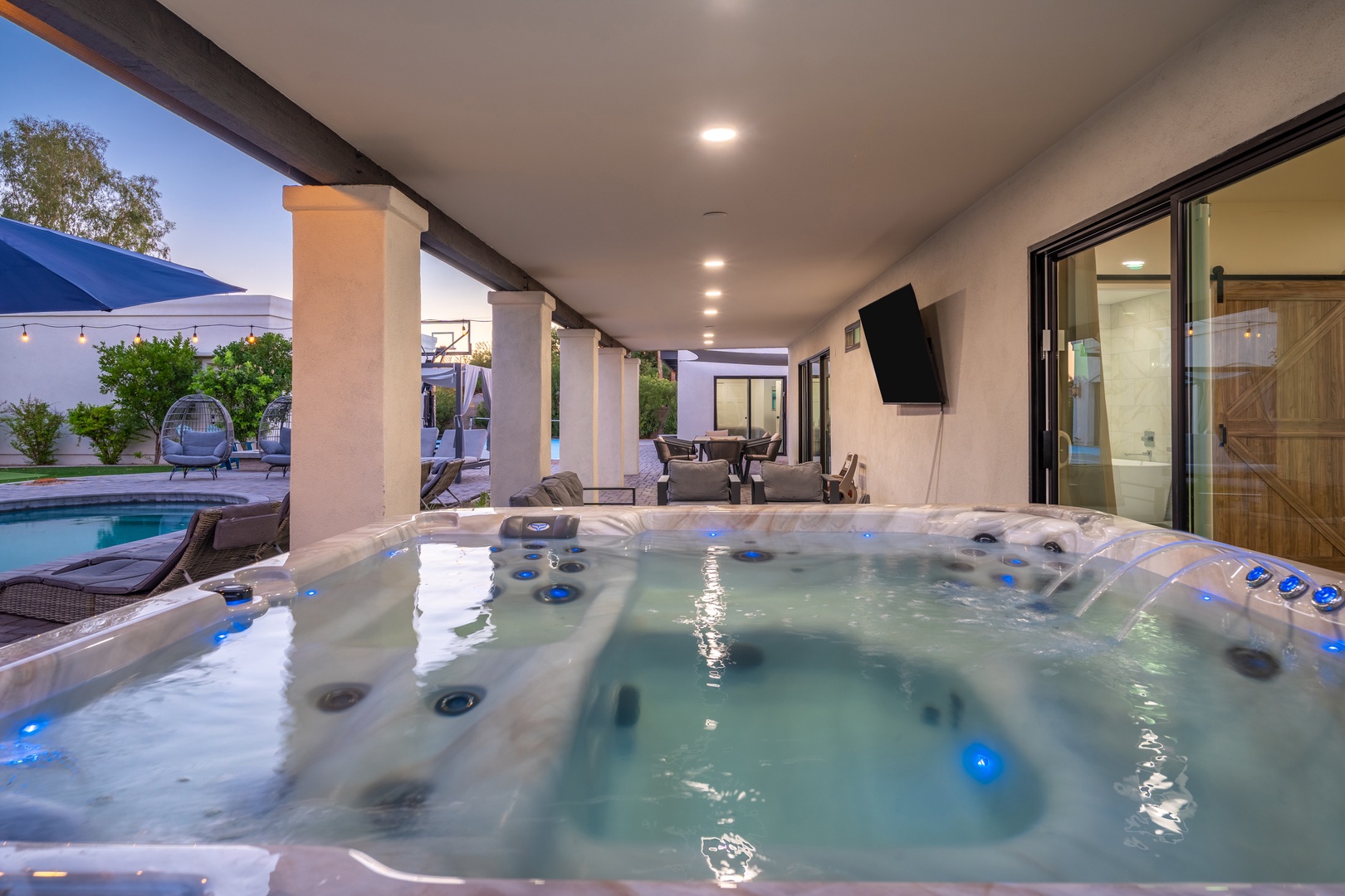 Slip into your private hot tub and let the warm, bubbling jets melt away stress as you gaze out at the pool and peaceful backyard oasis.
