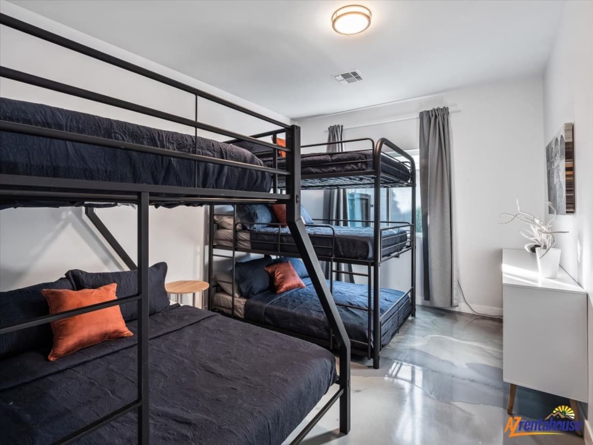 Your family room features four comfortable bunk beds with crisp linens and colorful accent pillows, perfect for group stays.