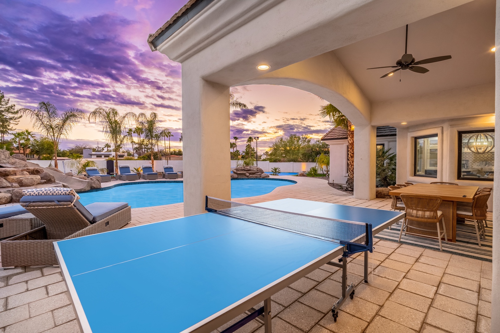 Enjoy a covered patio perfect for table tennis and relaxation, with direct access to your private pool and stunning sunset views over lush tropical surroundings.