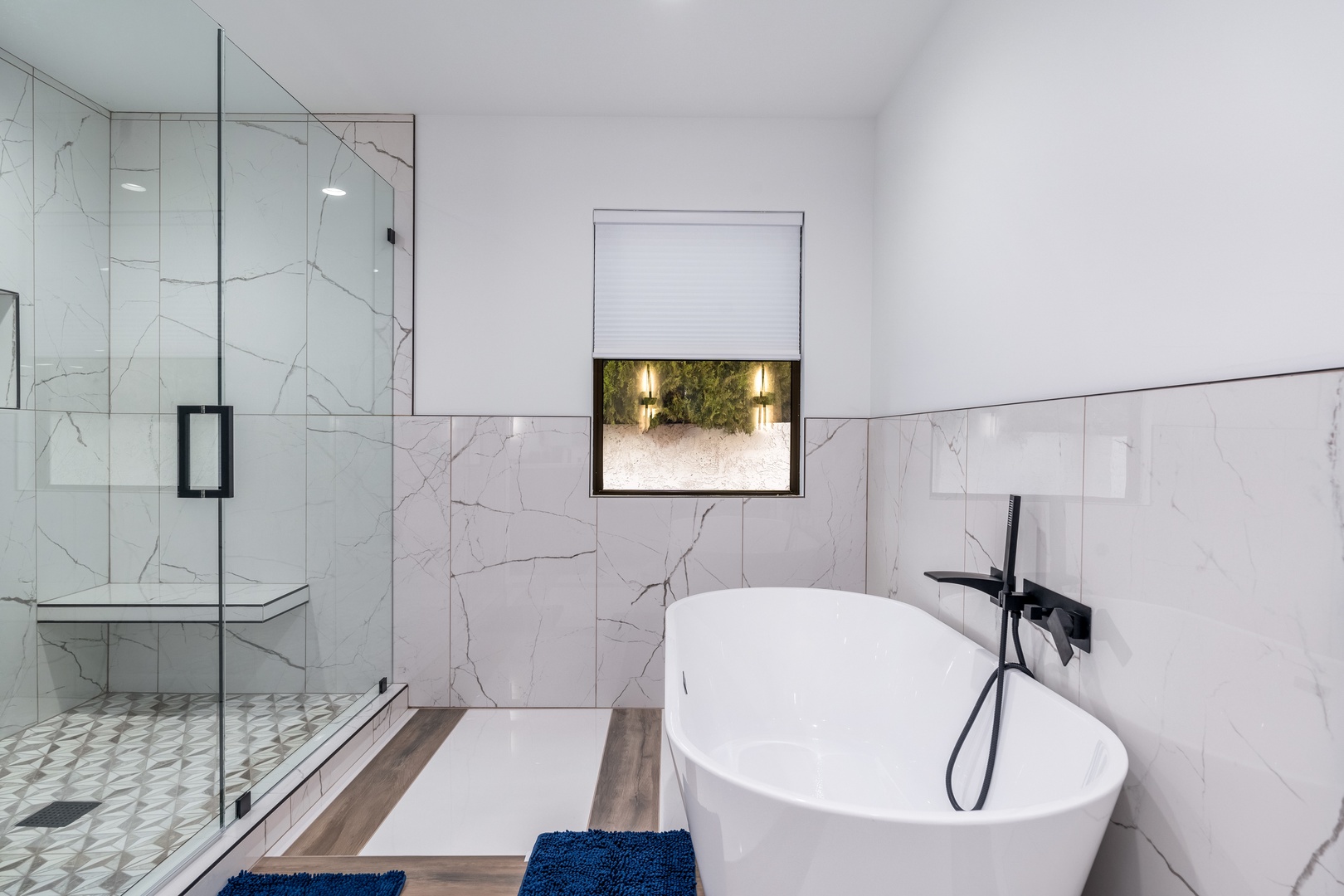 Unwind in your private spa-like bathroom featuring a sleek soaking tub, walk-in shower, and elegant marble-inspired finishes that invite pure relaxation.