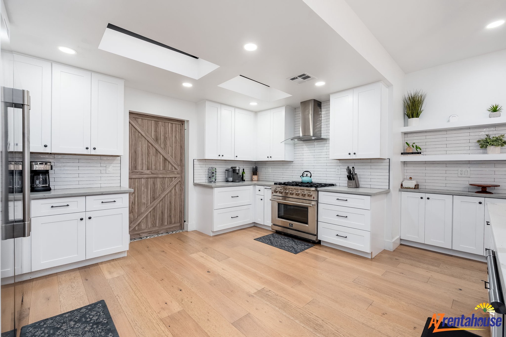 Your gourmet kitchen awaits with premium appliances, spacious counters, and warm wood floors perfect for cooking memorable meals together.