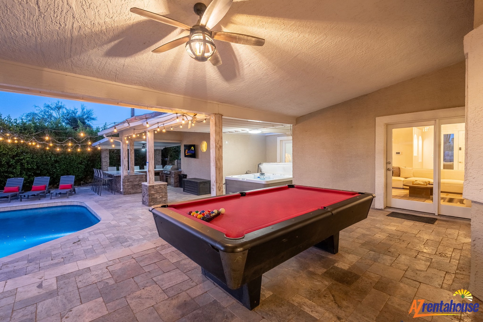 Step into your own private resort with a stunning covered patio featuring a billiard table, hot tub, and sparkling pool—your perfect setting for fun and relaxation under the stars.