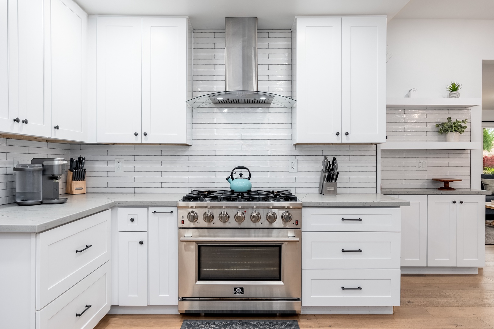 Your fully equipped kitchen features modern appliances, crisp white cabinetry, and sleek subway tile backsplash—perfect for preparing your favorite meals during your stay.