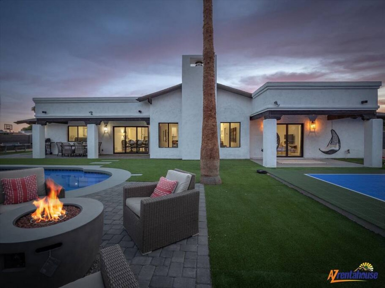 Modern desert villa with swimming pool, fire pit, and spacious outdoor areas perfect for relaxation.