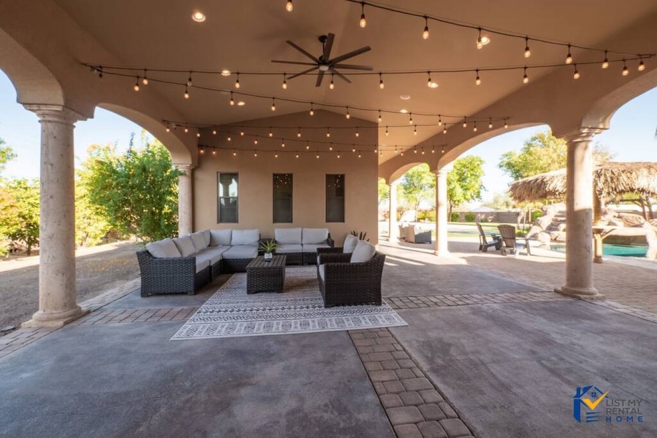 Unwind in your own covered patio paradise, where twinkling string lights create magical evenings and plush seating invites relaxation under the stars.