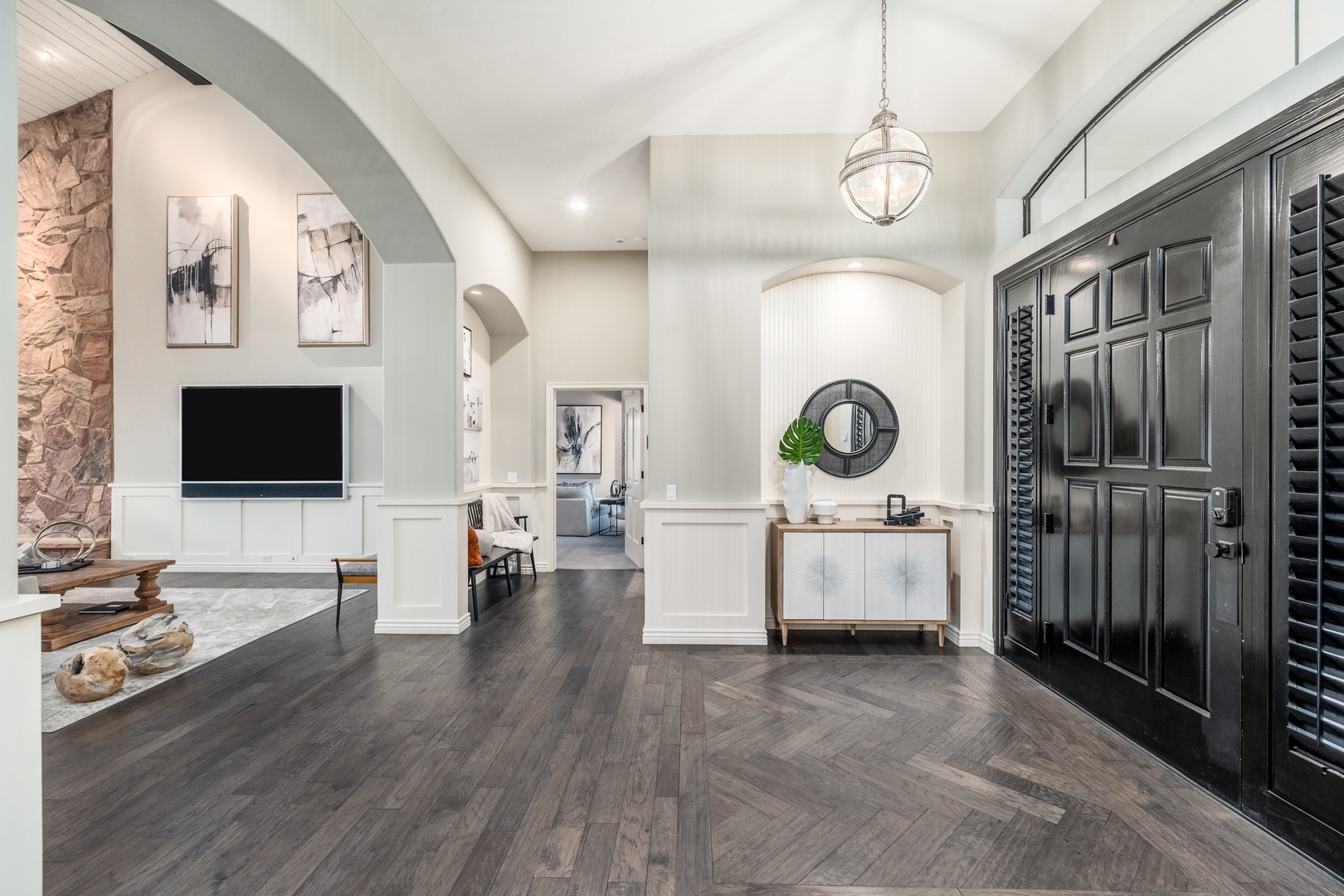 Step into your spacious retreat, where elegant arches frame soaring ceilings and rich hardwood floors guide your way. Relax in the bright living area with modern comforts, surrounded by stylish touches and natural warmth.